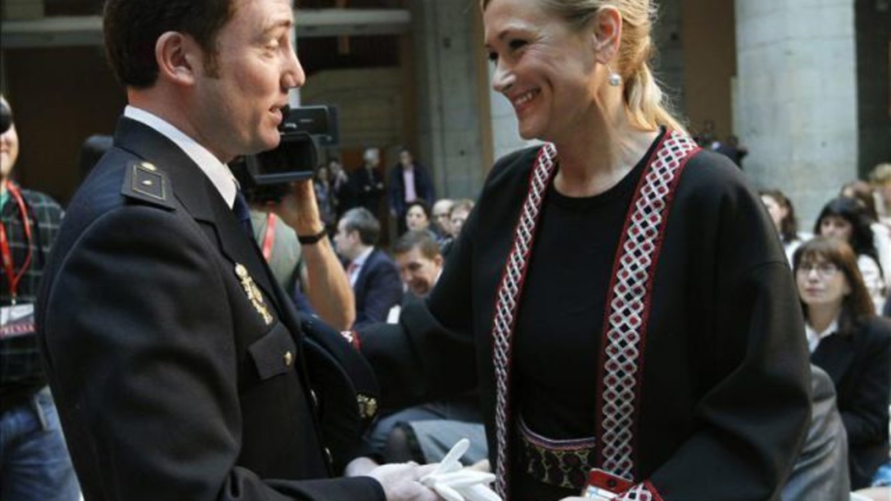 Cristina Cifuentes felicita a un policía nacional galardonado con la Medalla al Mérito Ciudadano.